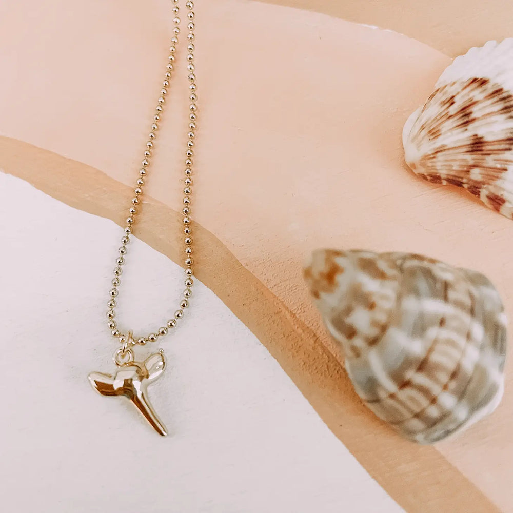 Gold shark tooth necklace