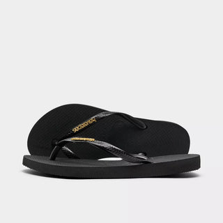 HAVAIANAS Black Logo Metallic Flip Flops in Golden