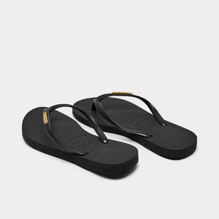 HAVAIANAS Black Logo Metallic Flip Flops in Golden